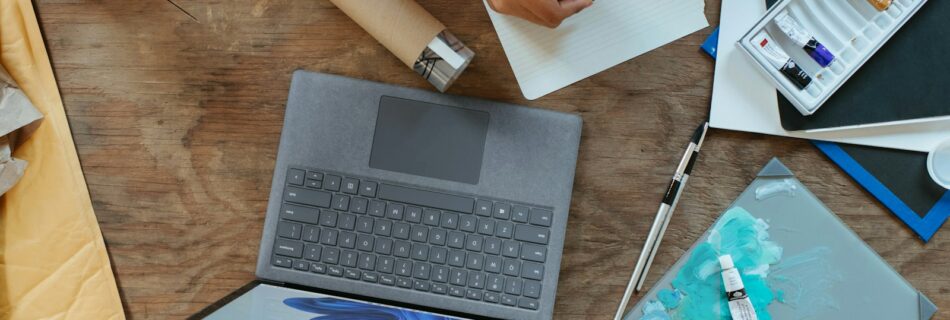 a laptop computer sitting on top of a wooden table