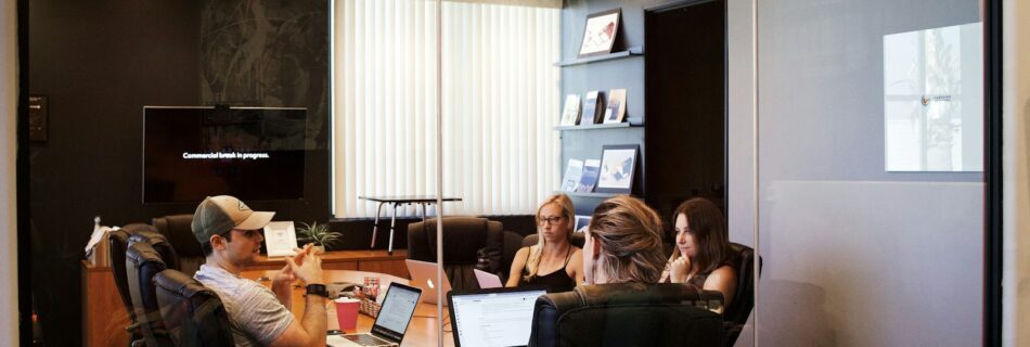 people sitting near table with laptop computer