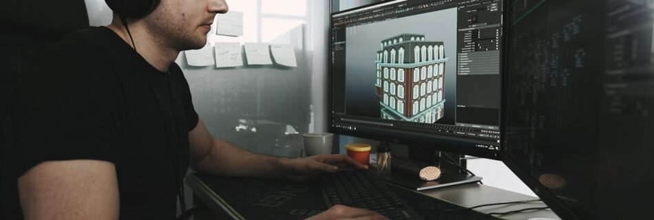 man in black tank top wearing black sunglasses using computer