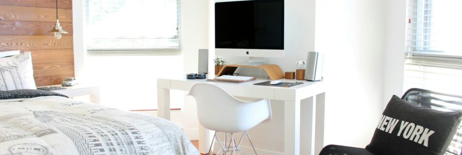 white wooden desk near bed inside the room