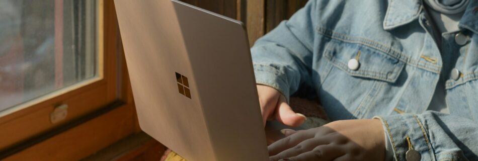 a woman sitting in a chair using a laptop computer